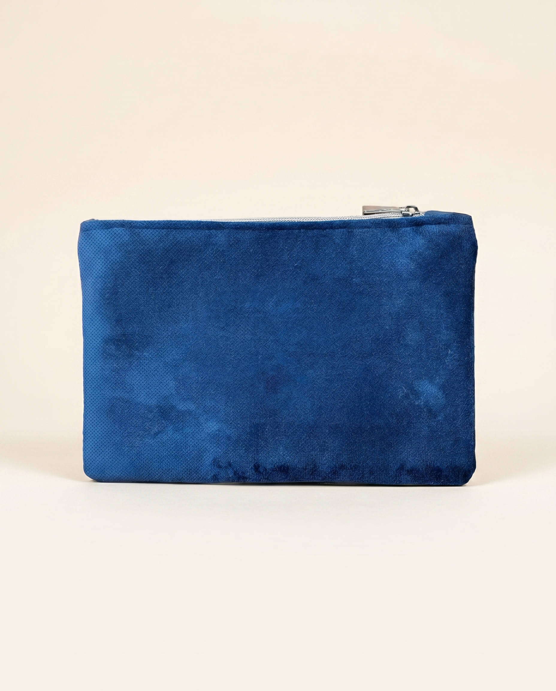 Navy velvet make-up pouch with hand-applied gold glitter initial on a clean white background